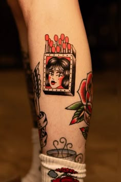 a woman's leg with tattoos on it