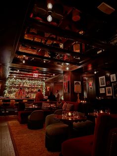 a dimly lit bar with candles on the tables