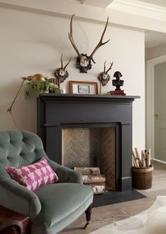 an image of a living room setting with deer heads on the wall above the fireplace