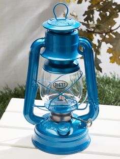 a blue lantern sitting on top of a white table