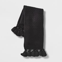 a black scarf with tassels on it