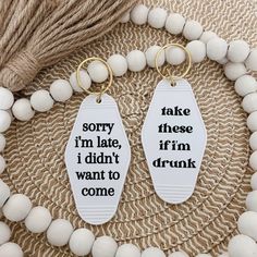 two key chains that say sorry, i'm late, i didn't want to come