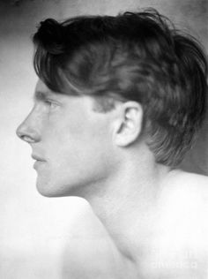 black and white photograph of a man with short hair looking to the side, in profile