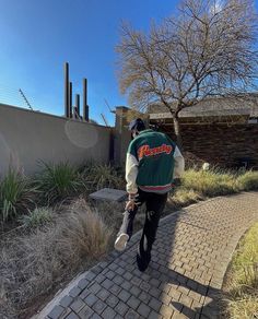 a man riding a skateboard down a brick walkway