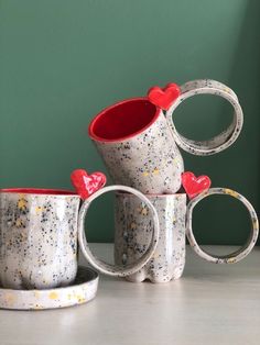 five coffee mugs with hearts on them sitting next to each other