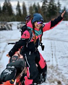 a woman riding on the back of a snowboard