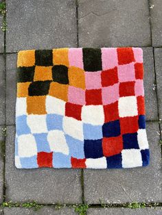 a multicolored rug is laying on the ground