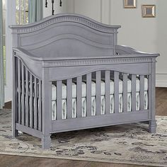 a baby crib in a room with a rug on the floor