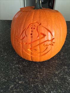 a carved pumpkin sitting on top of a counter next to a door with an elephant drawn on it