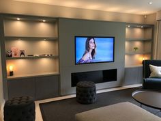 a large flat screen tv mounted to the side of a wall in a living room