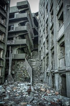 an abandoned building with stairs leading up to it