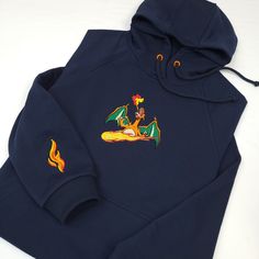 a blue hoodie with an image of a dragon on the front and yellow flames on the back