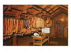 some meat hanging from hooks in a room