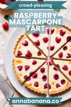 raspberry mascarpone tart on a white plate with strawberries around it