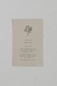 the back of a wedding card with a flower on it, printed in black ink