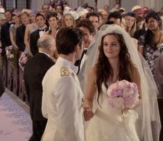 a bride and groom walking down the aisle