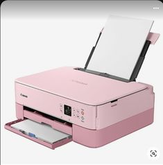 a pink printer sitting on top of a white table next to a paper tray with a piece of paper sticking out of it