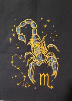 zodiac sign with scorpion embroidered on black t - shirt