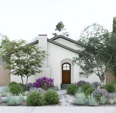 a white house with purple flowers and trees