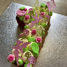 a cake decorated with pink and green decorations