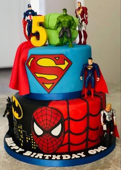 the birthday cake is decorated with superhero figures