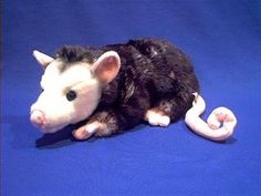 a stuffed animal that is laying down on a blue surface