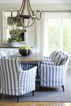 a dining room with blue and white striped chairs