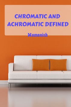 a couch sitting in front of an orange wall with the words chromatic and achromatic defined on it