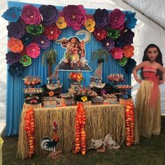 the table is decorated with paper flowers and decorations