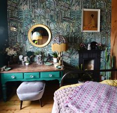 a bedroom with green wallpaper and a bed in the corner next to a dresser