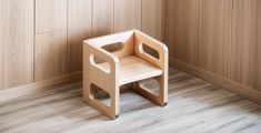 a small wooden step stool sitting on top of a hard wood floor next to a wall