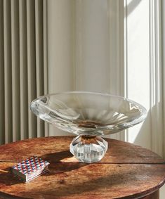 a glass bowl sitting on top of a wooden table