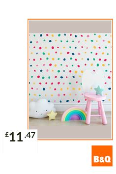 a child's room with colorful polka dot wallpaper and a rainbow toy on the floor