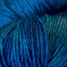 blue and green yarn is shown in this image