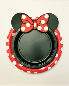 a red and white paper plate with a minnie mouse head on it's side