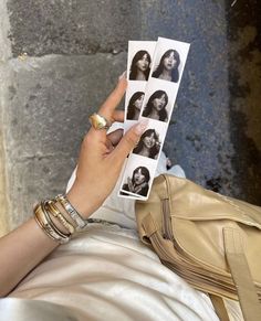 a woman holding up four photos of herself