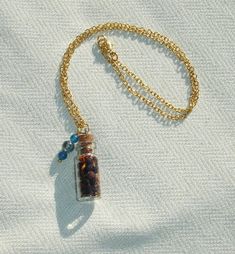 This mini glass spell bottle measures 3/4". It features herbs that correspond with health. Also, features blue kyanite gemstone beads. Gold plated necklace measures 17" length. Blue Kyanite, Gold Plated Necklace, Gemstone Beads