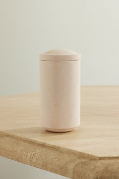 a white container sitting on top of a wooden table