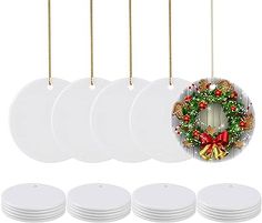 a set of six white plates with christmas wreath hanging from the front and four empty plates on each side