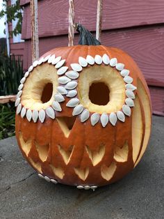 a carved pumpkin with an owl face on it