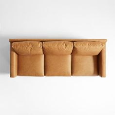 the couch is made out of cardboard and has four pillows on it