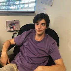 a young man sitting in an office chair