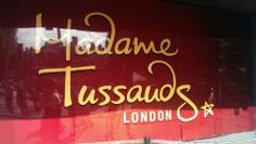 there is a red sign that says madame tussauds london