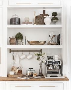 the shelves in this kitchen are filled with coffee and other things to make it look like they