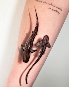 an arm with two lizards on it and the words, i am not sure what they are