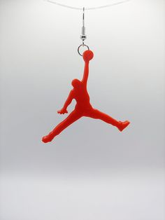 The legend of Jordan continues to be told, carried on by fans and enthusiasts wanting to perpetuate greatness.  Show your respects for the greatest by wearing these lightweight and colorful earrings as a homage to Jordan. 3D printed using PLA filament, these earrings are attached to rhodium colored hangers and come in your choice of 5 colors.  40mm x 25mm x 4mm, these are the perfect size to make a statement without feeling or appearing excessively. Air Jordan Logo, 3d Earrings, Jordan Logo, 3d Printed Jewelry, Printed Jewelry, Colorful Earrings, 3d Logo, Hang Tags, 3d Printed