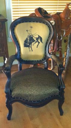 an old chair with a horse drawn on it