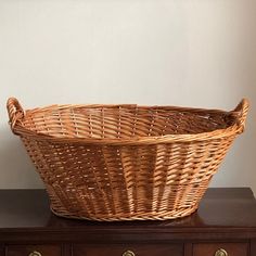 a wicker basket sitting on top of a dresser