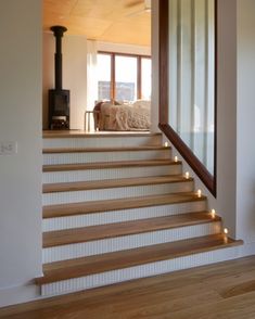 there is a stair case with lights on the bottom and side steps to the second floor