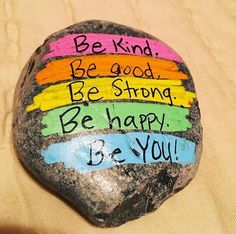 a rock with the words be kind, be strong and be happy on it